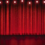 spotlight on red stage curtain