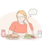 woman thinking about choosing fast food or vegan food