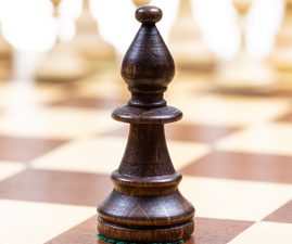 A bishop on a chess board, which moves diagonally, symbolizes that weight loss and achieving wellness takes long-range planning.