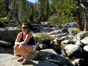 Michelle sitting on rocks during a hike