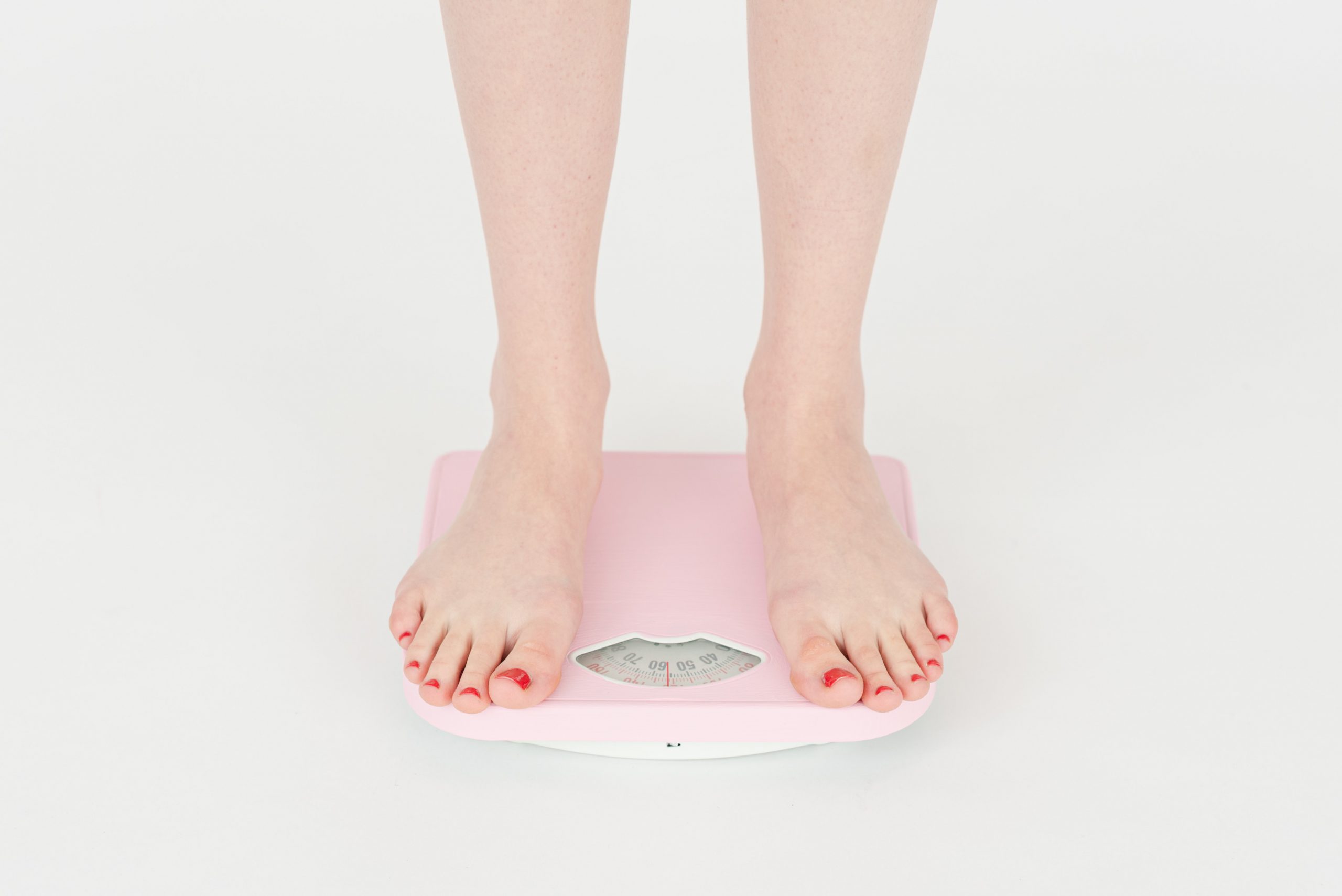 Woman's feet standing on scale