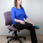 Maggie doing seated hip stretch