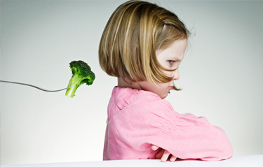 Child turned away from broccoli