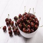 using a bowl of cherries to make a healthy smoothie