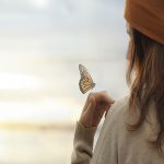 focus on the present by letting a butterfly lay on your hand