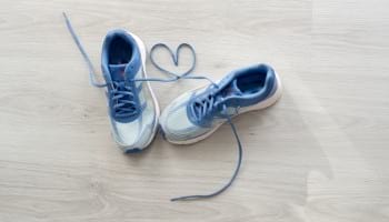 Blue sneakers with heart made from shoelaces