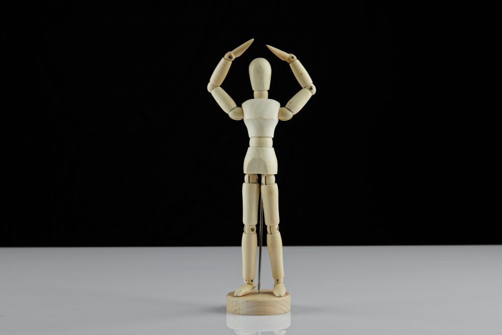 A jig doll with it's arms raised, representing when you've had 'enough' or reached your limit.